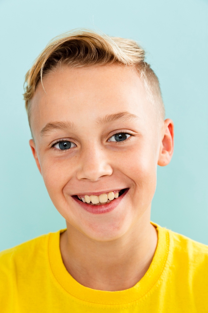 boy smiling in full teeth
