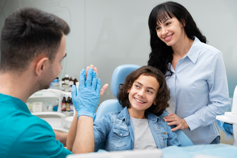 happy boy with a dentist and mom