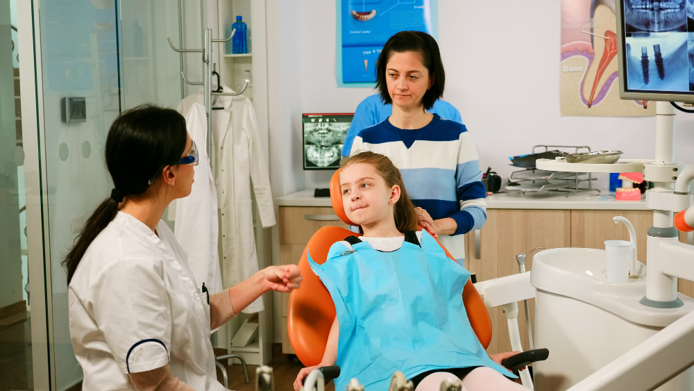 parent and child with a dentist in dental clinic