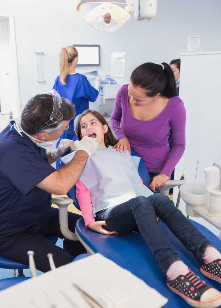 parent and child with a dentist