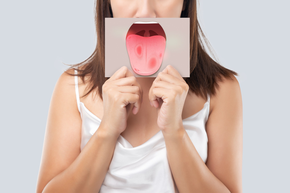 woman holding a picture covered on her mouth