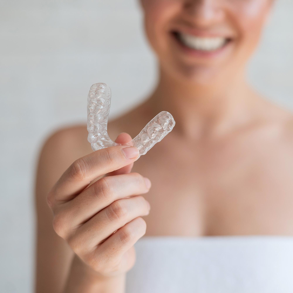 woman holding invisalign