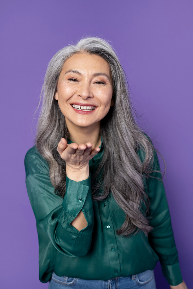 woman in mid 60s with perfect teeth smiling